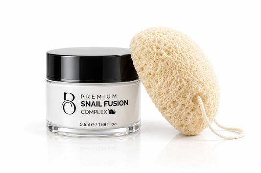 The Boudoir Glow Set: Premium Snail Fusion Complex jar with a natural konjac sponge on a white background