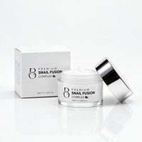 Premium Snail Fusion Complex 50ml jar, open with cream visible, beside its box on a white background